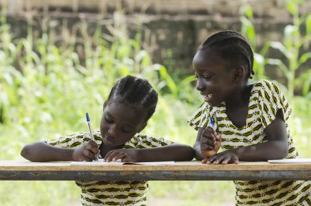 Two African girls doing school work.