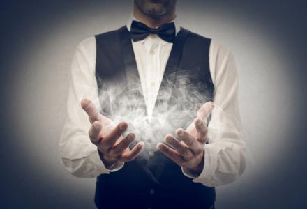 A magician with smoke in his hands.
