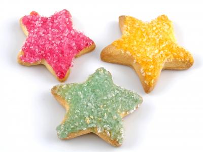 Star-shaped sugar cookies with pink, green and yellow frosting.