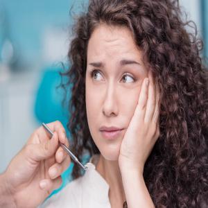 A woman suffering from a toothache.