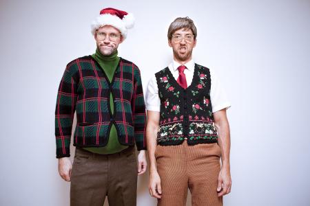 Two men in ugly christmas sweaters.