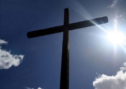 Humble Wooden Cross with Bright Sunburst