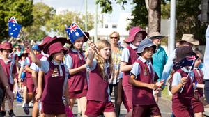 Australian school children in uniform marching in an Anzac Day parade.