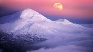 Moonrise over alpine peaks in Utah.