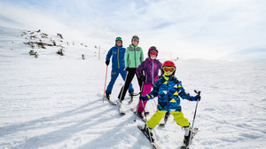Family of four skiing. 