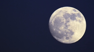 Zoomed in image of the Full Moon with its surface of craters and mountains.