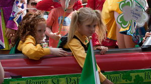 Two girs dressed in yellow and green in a St. Patric's Day's parade in Sydney, Australia.