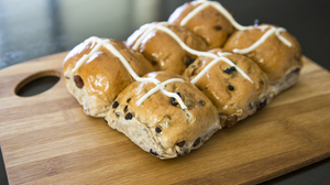 Hot cross buns for Easter on a wooden board.