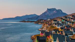 Colorful houses in an arctic bay at sunset. 