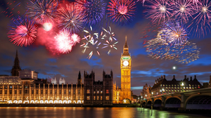 Night view of the clocktower Big Ben in London, with a sky full of colorful fireworks.