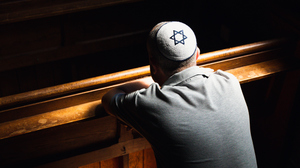 Jewish man wearing a skull cap in temple