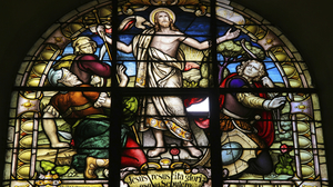 Glass church window depicting the resurrection of Jesus Christ on Easter morning.