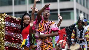 Children in colorful clothes wave on a float wave to the crowd during the annual Juneteenth parade in Philadelphia, Pennsylvania, on June 23, 2018.