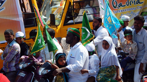 Indian Muslim men and children on scooters in a public procession on Milad un Nabi.