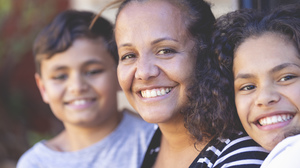 Close up portrait of an Aboriginal mother and her son and daughter.