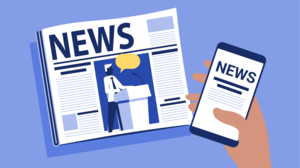 A newspaper folded in half lying on the surface. Hand holding a mobile phone displaying news page.