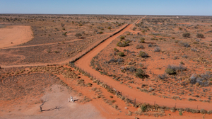 A photo showing a red earth desert area in Australia where three different time zones meet.