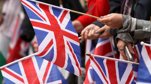 People waving small Union Jack flags.