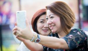 Two friends taking a selfie together.