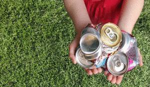 Aluminum cans crushed For recycling in a Child's hands.