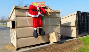 Santa suit discarded in a trash can.