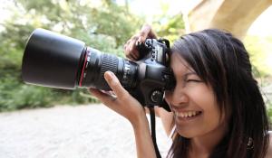 Woman photographer taking pictures in nature.