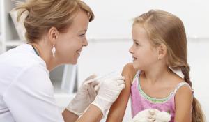 School nurse administering an injection to a child.