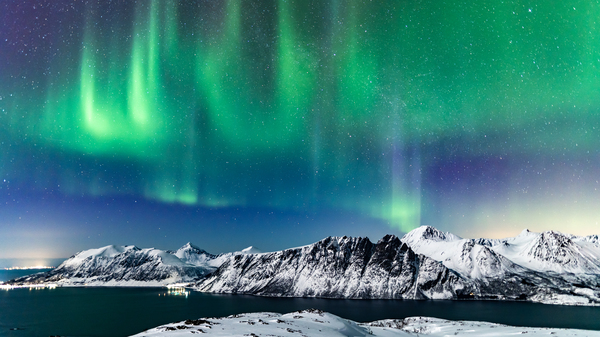 The aurora borealis over mountains in Harstad, northern Norway.