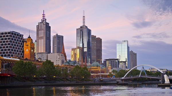 Melbourne skyline at sunset under a beautiful mauve sky.