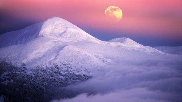 Moonrise over alpine peaks in Utah.