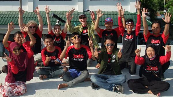 Indonesian students are cheering after a solar eclipse.