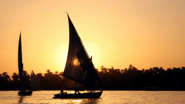 Sailing a felucca, a type of sailing boat, on the Nile River in Luxor, Egypt.