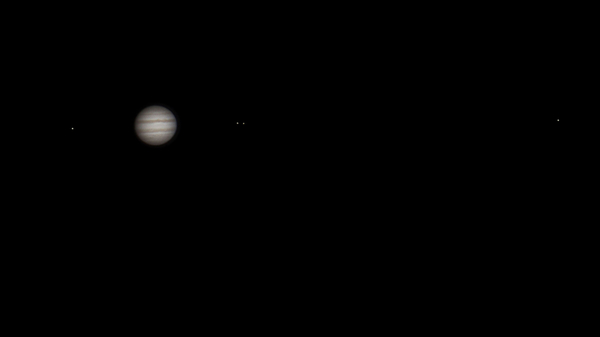 Telescope view of Jupiter and its four Galilean moons