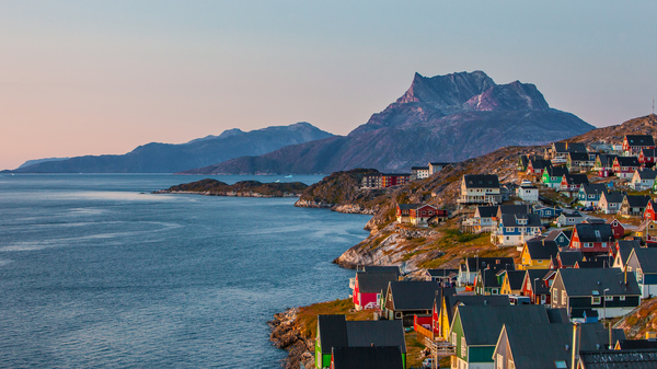 Colorful houses in an arctic bay at sunset.