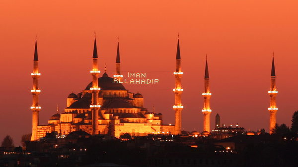 Red and yellow Illuminated mosque in Istanbul
