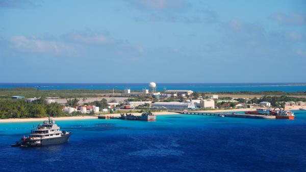 Aerial view of an island surrounded by clear blue ocean.