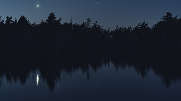 Venus in the night sky, shining over a lake in Nova Scotia