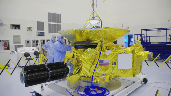 NASA technicians work on the New Horizons spacecraft at the Kennedy Space Center in November 2005.