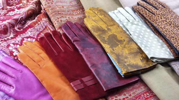 Several pairs of colorful fashionable ladies gloves on display.