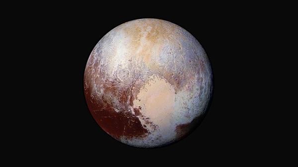 Four images from NASA's New Horizons' Long Range Reconnaissance Imager (LORRI) were combined with color data from the Ralph instrument to create this global view of Pluto.