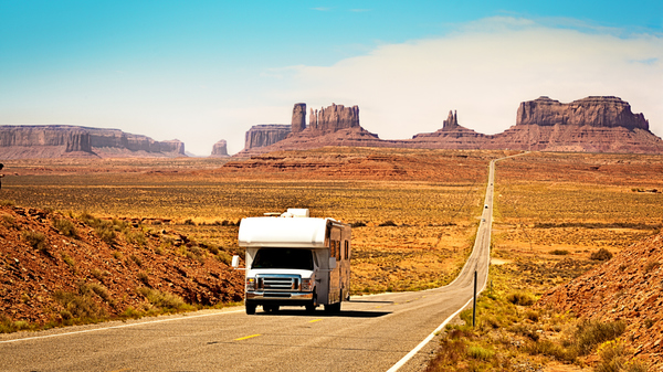 A Recreational Vehicle RV camper driving on the highway at the scenic Monument Valley Tribal Park in Arizona, USA