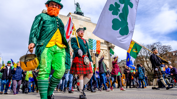 Man in a leprechaun costume walks in a St. Patrick´s Day parade.