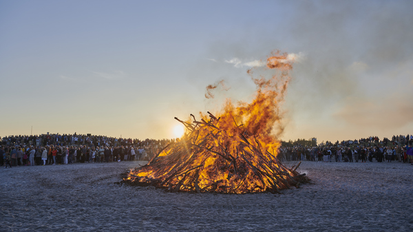 Midsummer night at the beach in Skagen with bonfire as symbol of long summer days.