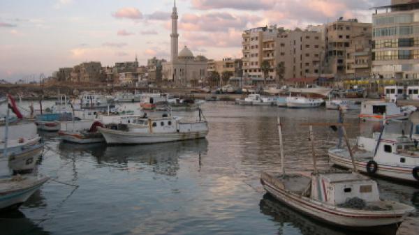 Photo of a Small Syrian harbour in Tartus, showing boats and buildings in the background