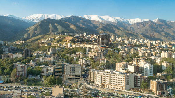 Panorama of Tehran, looking to the north, with high rise buildings and snowcapped mountains behind,