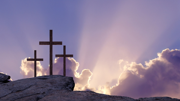 Three crosses on a mountain, signifying Easter or the resurrection of Christ