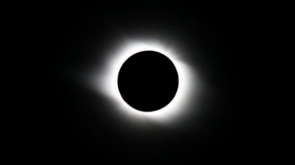 Total solar eclipse at its maximum point or totality. (Illustration)