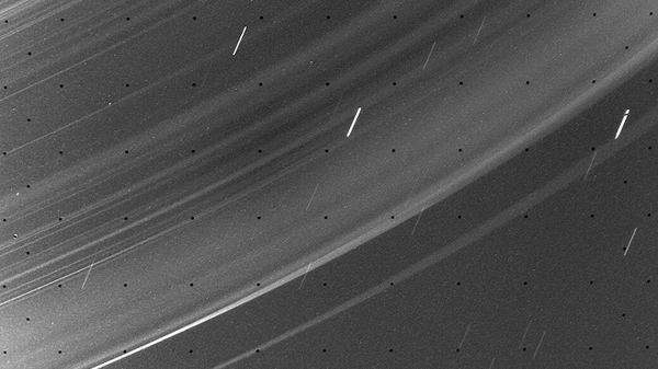 An image of the rings of Uranus, taken by the Voyager 2 spacecraft. The width of the frame is about 10,000 km (6200 mi). The short streaks are stars moving in the background.