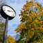 Clock in a city park during fall (autumn).