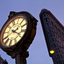 Fifth Avenue Clock with the Flatiron Building at the background in New York City.